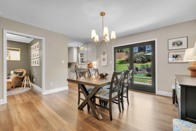 2809 Trebark Dr, Tallahassee, FL 32312 - dining space with light wood-style floors and a chandelier