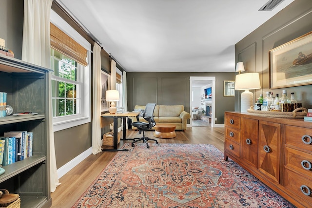 2809 Trebark Dr, Tallahassee, FL 32312 - office space featuring wood finished floors and a fireplace