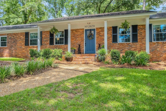 2809 Trebark Dr, Tallahassee, FL 32312 - single story home featuring brick siding, a porch, and a front yard