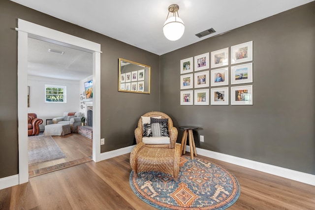 2809 Trebark Dr, Tallahassee, FL 32312 - sitting room featuring wood finished floors and a fireplace with raised hearth