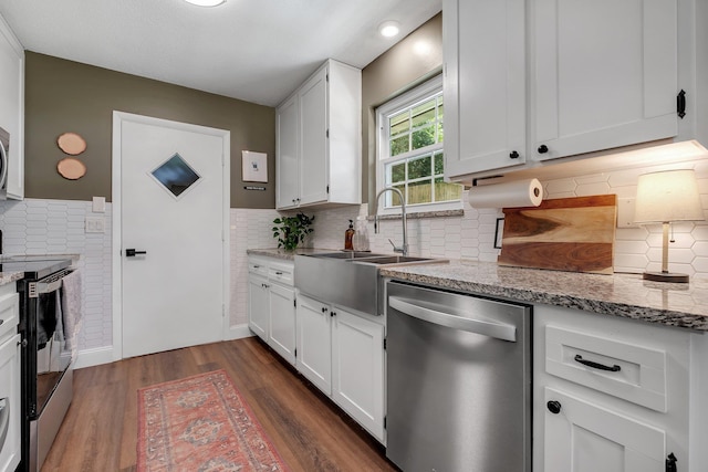 2809 Trebark Dr, Tallahassee, FL 32312 - kitchen featuring stainless steel appliances, white cabinets, dark wood-style floors, light stone counters, and backsplash