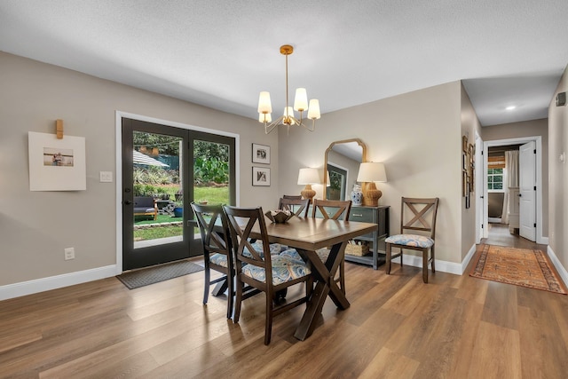 2809 Trebark Dr, Tallahassee, FL 32312 - dining room featuring wood finished floors, healthy amount of natural light, and a chandelier