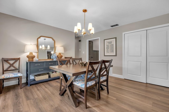 2809 Trebark Dr, Tallahassee, FL 32312 - dining room with a chandelier and wood finished floors