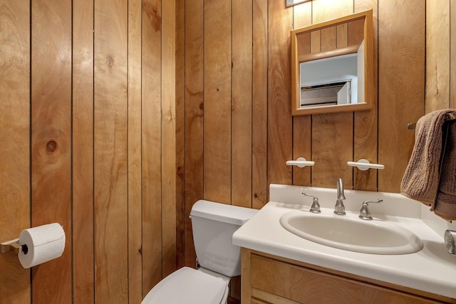 2003 Chuli Nene, Tallahassee, FL 32301 - bathroom with toilet, vanity, and wooden walls