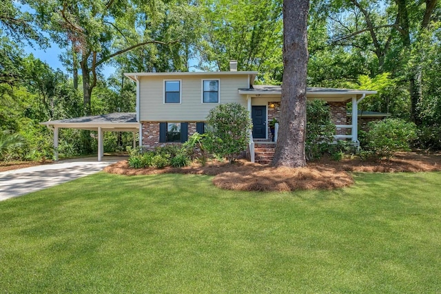 2003 Chuli Nene, Tallahassee, FL 32301 - split level home with brick siding, a front yard, a chimney, and concrete driveway