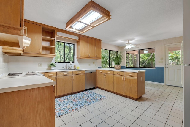 2003 Chuli Nene, Tallahassee, FL 32301 - kitchen with stainless steel dishwasher, a sink, open shelves, a peninsula, and ceiling fan