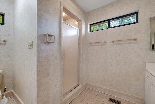 2003 Chuli Nene, Tallahassee, FL 32301 - bathroom featuring tile patterned flooring, a shower stall, vanity, and baseboards