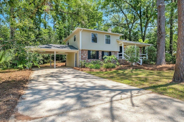 2003 Chuli Nene, Tallahassee, FL 32301 - split level home featuring concrete driveway, brick siding, a front yard, a chimney, and an attached carport