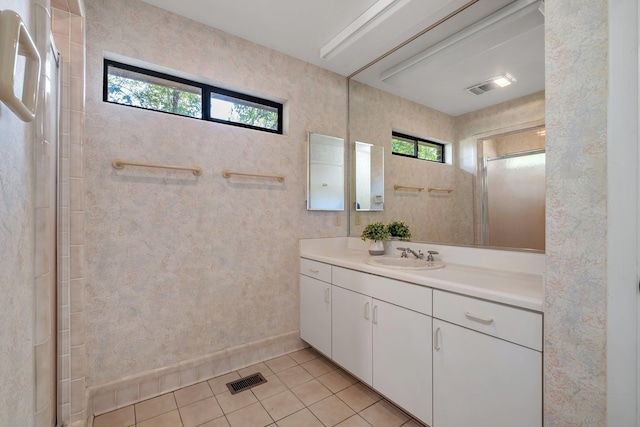2003 Chuli Nene, Tallahassee, FL 32301 - full bath with healthy amount of natural light, vanity, tile patterned floors, and a shower with door