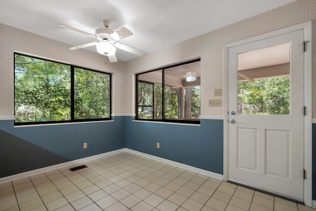 2003 Chuli Nene, Tallahassee, FL 32301 - spare room with wainscoting, healthy amount of natural light, wallpapered walls, and ceiling fan