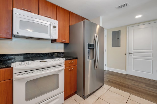 300 S Duval St Unit 612, Tallahassee, FL 32301 - kitchen featuring white appliances, brown cabinetry, light tile patterned flooring, electric panel, and recessed lighting
