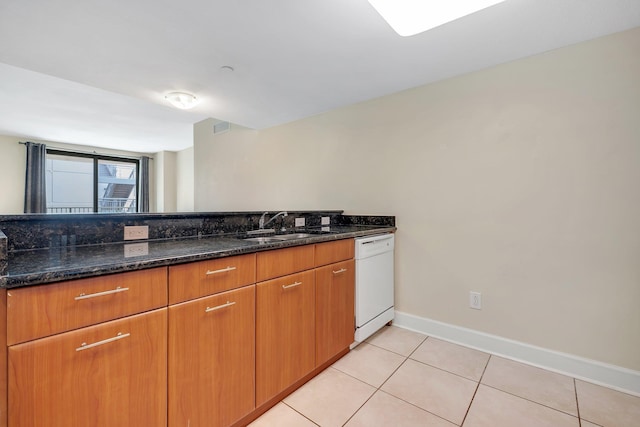 300 S Duval St Unit 612, Tallahassee, FL 32301 - kitchen with dishwasher, dark stone countertops, light tile patterned flooring, and brown cabinetry