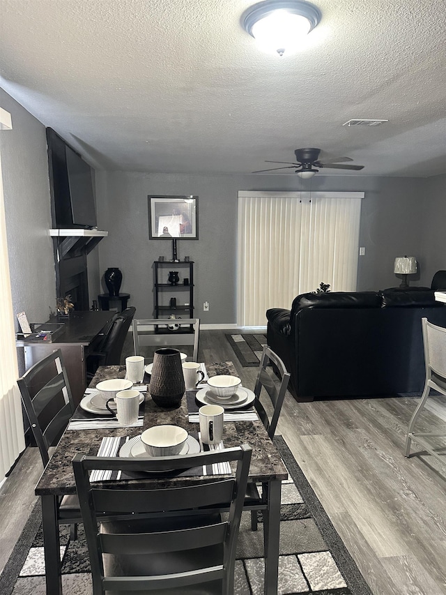 1216 Hidden Pl, Tallahassee, FL 32304 - dining space with a textured ceiling, ceiling fan, and wood finished floors