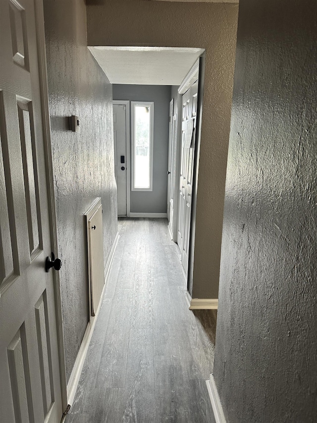 1216 Hidden Pl, Tallahassee, FL 32304 - hall featuring baseboards, wood finished floors, and a textured wall