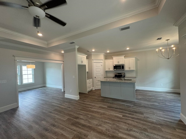 kitchen featuring dark hardwood / wood-style floors, appliances with stainless steel finishes, ornamental molding, and white cabinets