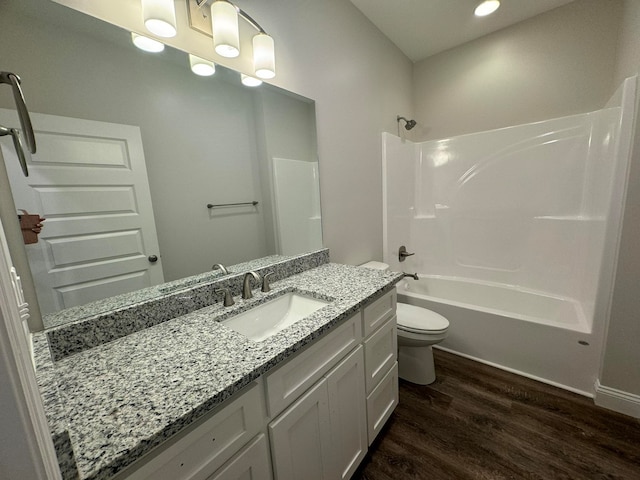 full bathroom with wood-type flooring, vanity, toilet, and shower / bathing tub combination