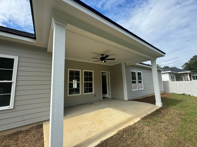 exterior space with ceiling fan, a yard, and a patio