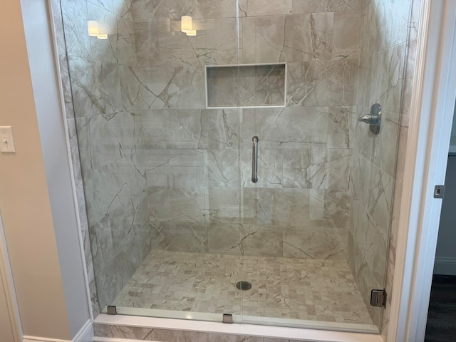 bathroom with a shower with shower door