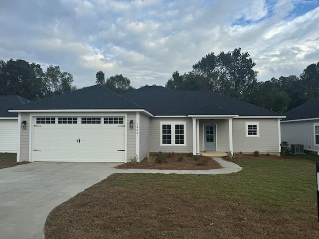 ranch-style home with a garage, central AC, and a front lawn