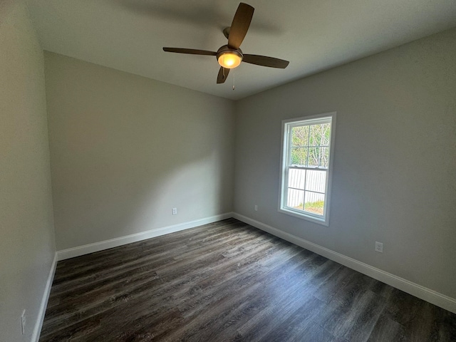 spare room featuring ceiling fan and dark hardwood / wood-style floors