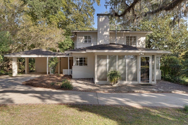 rear view of property with a carport