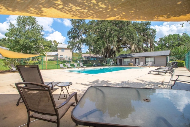 view of swimming pool featuring a patio area