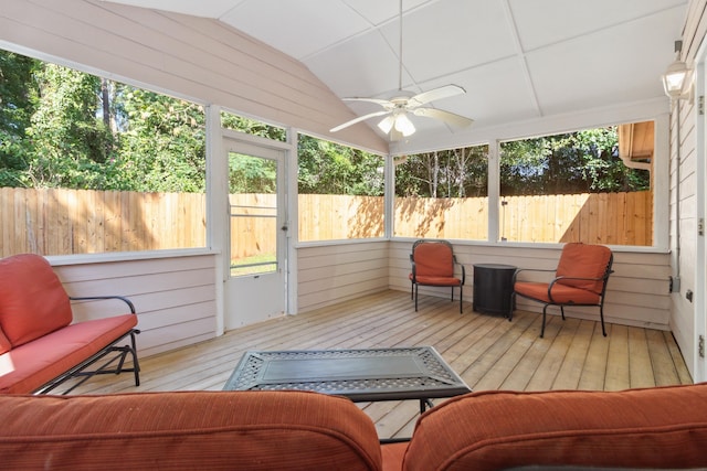 sunroom / solarium with ceiling fan and vaulted ceiling