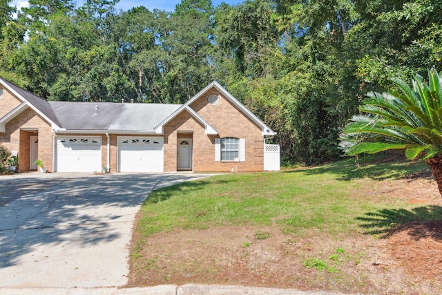 view of front of property featuring a garage and a front lawn