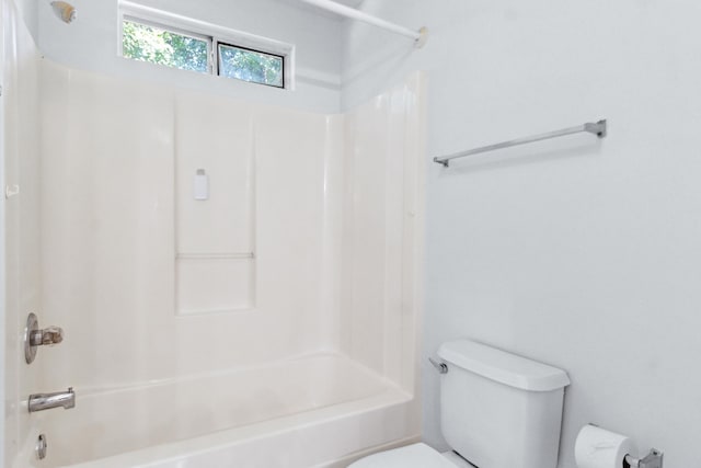 bathroom featuring bathtub / shower combination and toilet