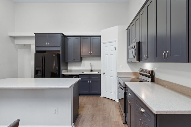 kitchen featuring sink, light wood-type flooring, and appliances with stainless steel finishes