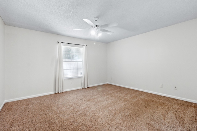 carpeted spare room with ceiling fan and a textured ceiling