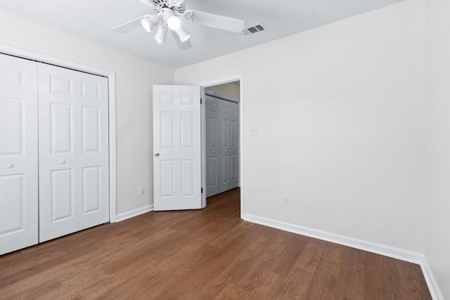 unfurnished bedroom with hardwood / wood-style flooring, ceiling fan, and a closet