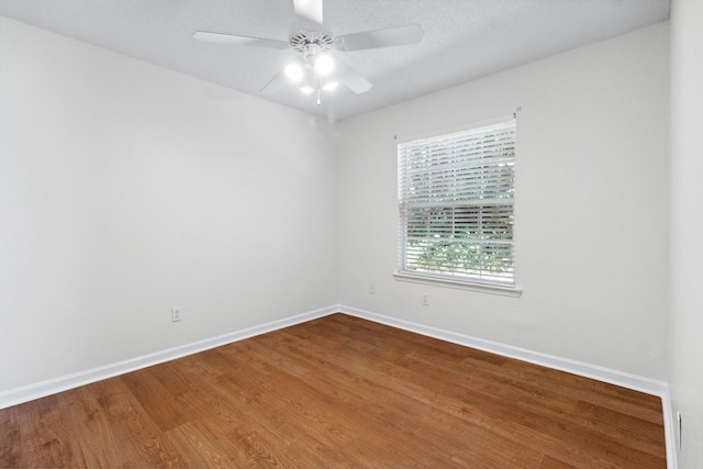 spare room featuring wood-type flooring and ceiling fan