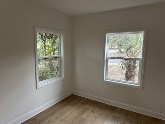 unfurnished room featuring light wood-type flooring and baseboards