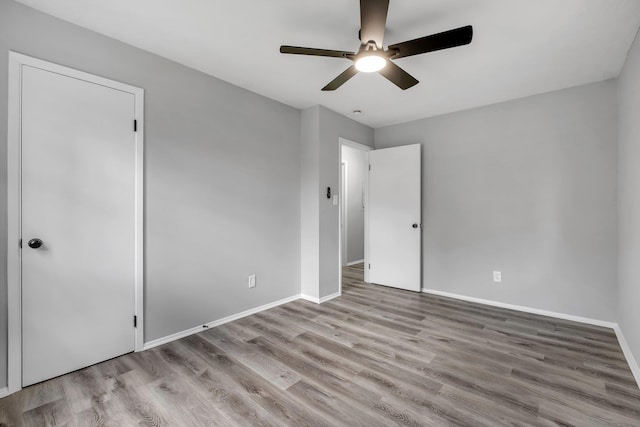 2124 Berkshire Dr, Tallahassee, FL 32304 - unfurnished bedroom with wood finished floors, baseboards, and a ceiling fan