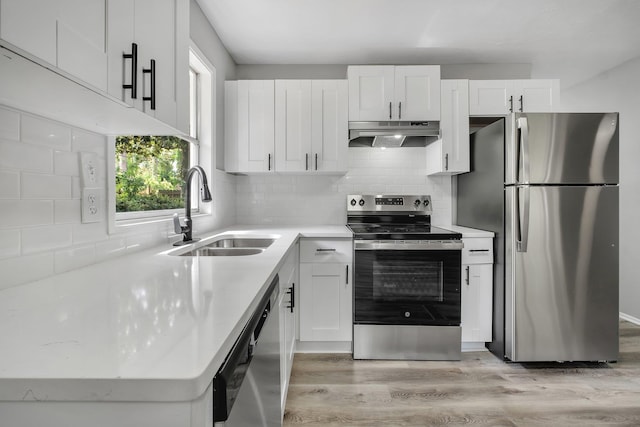 2124 Berkshire Dr, Tallahassee, FL 32304 - kitchen featuring appliances with stainless steel finishes, a sink, under cabinet range hood, and white cabinetry