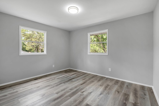 2124 Berkshire Dr, Tallahassee, FL 32304 - empty room featuring plenty of natural light, baseboards, and wood finished floors