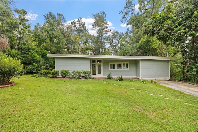 single story home featuring a front yard and french doors