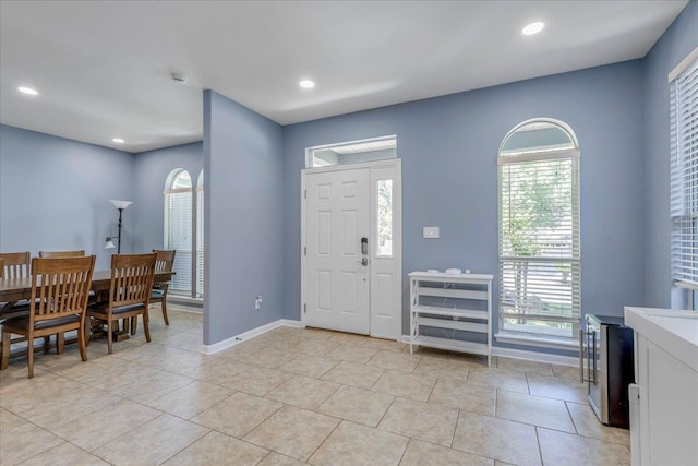 foyer featuring light tile patterned floors, baseboards, plenty of natural light, and recessed lighting