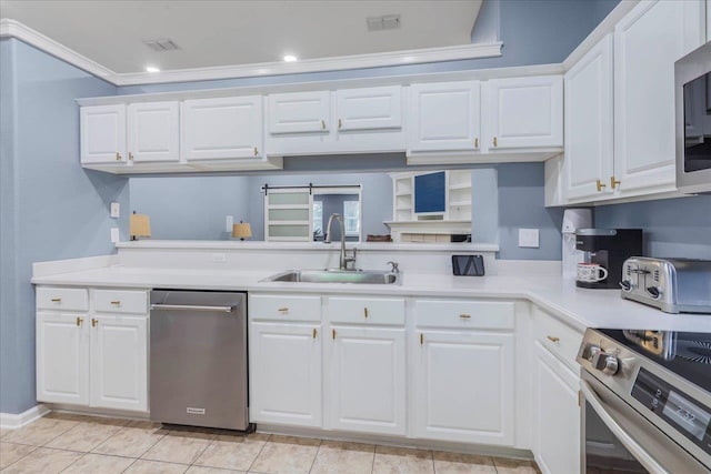 kitchen with light countertops, a sink, white cabinets, and stainless steel appliances