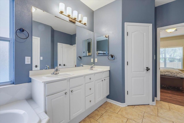 bathroom with a sink, tile patterned flooring, double vanity, and connected bathroom