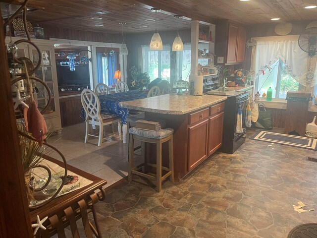 kitchen with wooden ceiling, a kitchen bar, and decorative light fixtures