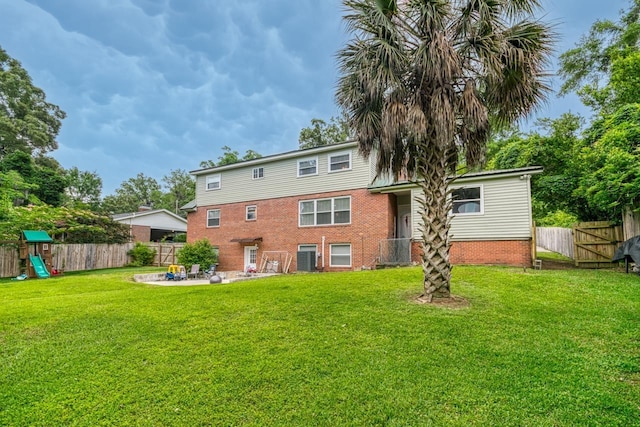 2310 Don Andres Ave, Tallahassee, FL 32304 - rear view of house featuring a patio area, brick siding, and a playground