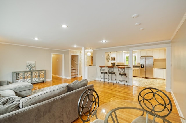 2310 Don Andres Ave, Tallahassee, FL 32304 - living room with crown molding, stairs, light wood-style floors, baseboards, and recessed lighting