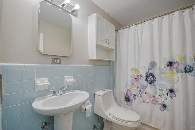 2310 Don Andres Ave, Tallahassee, FL 32304 - bathroom featuring tile walls, toilet, a shower with curtain, and a wainscoted wall