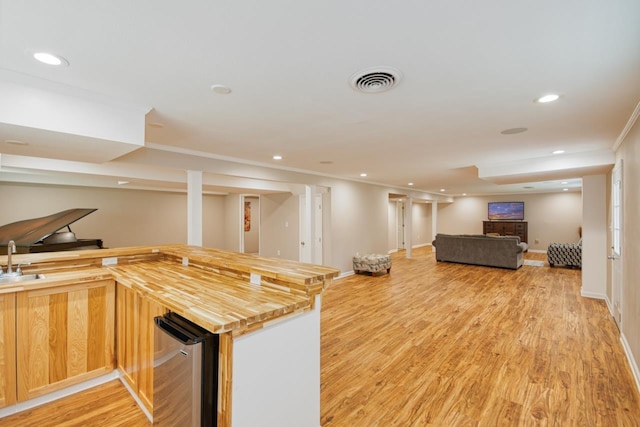 2310 Don Andres Ave, Tallahassee, FL 32304 - kitchen featuring butcher block countertops, recessed lighting, a sink, light wood-style floors, and open floor plan