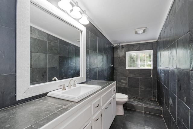 2310 Don Andres Ave, Tallahassee, FL 32304 - full bath with a tile shower, tile walls, toilet, vanity, and tile patterned flooring