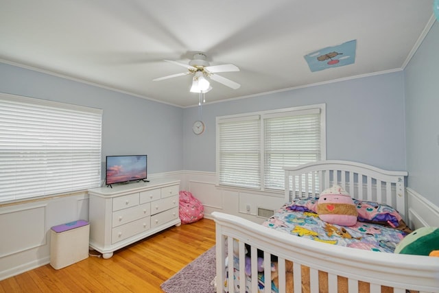 2310 Don Andres Ave, Tallahassee, FL 32304 - bedroom featuring light wood-type flooring, a wainscoted wall, crown molding, and ceiling fan