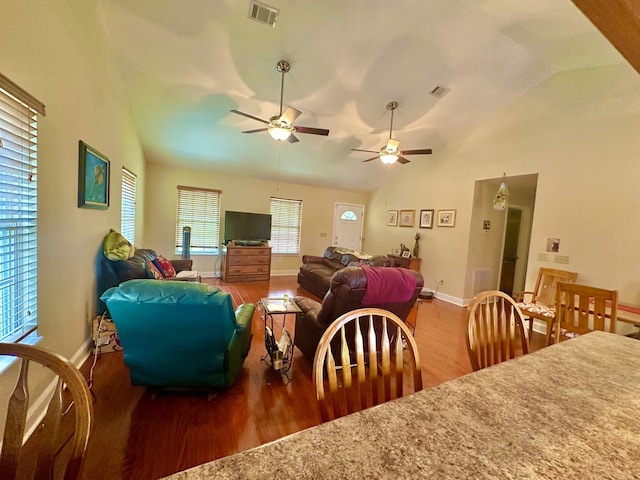 dining area with vaulted ceiling and hardwood / wood-style floors