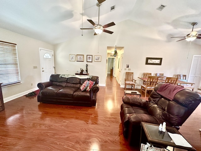 living room with hardwood / wood-style flooring, ceiling fan, and high vaulted ceiling